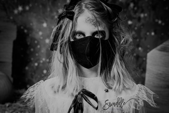 zombie girl with blonde hair wearing a black mask