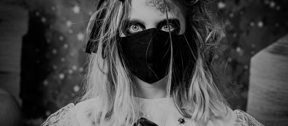 zombie girl with blonde hair wearing a black mask